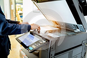 Bussiness man Hand press button on panel of printer, printer scanner laser office copy machine supplies start concept