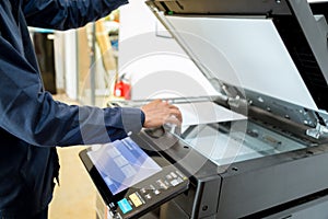 Bussiness man Hand press button on panel of printer, printer scanner laser office copy machine supplies start concept