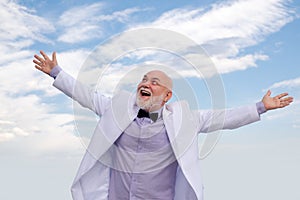 Bussiness success. Old senior mature man. Vintage successful male bussinessman in white suit having fun.