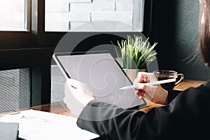 Bussiness working on tablet computer with blank screen at office desk