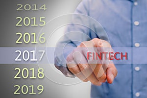 Bussinessman hand pointing fintech text for 2017. targets conce