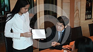 Bussinesswoman using tablet for presentation during business.