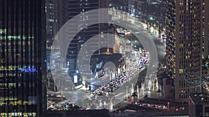 Bussy traffic on the intersection in Dubai downtown aerial night timelapse.