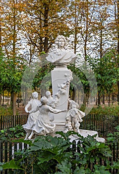 A bust of the French author, Charles Perrault and one of his most famous characters, Puss in Boots, in the Tuileries garden, Paris