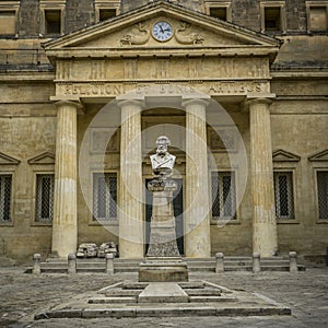 Bust in front of building photo