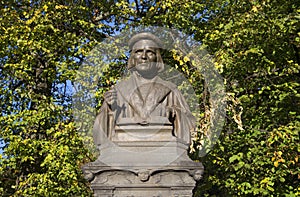 Bust of Mikael Agricola in the background of autumn foliage. Vyborg