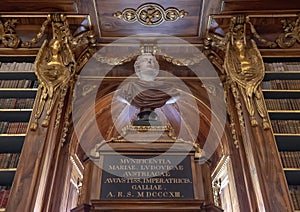 Bust and partial view of bookshelves in the Philosophical Hall, Strahov Monastery Library, Praque photo