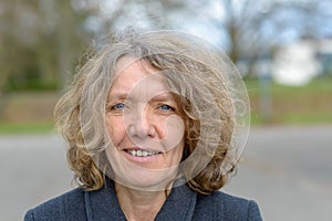 Bust portrait of smiling middle aged woman