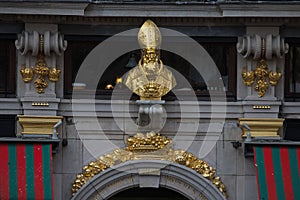 Bust of Saint Aubert on the facade of the house Le Roy d`Espagne photo