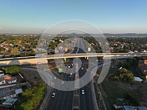 a bustling highway running between residential buildings and a bridge, Gaborone, Botswana, Africa