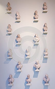 Busts sculptures hanging on wall abstract