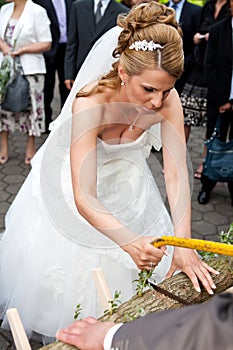 Busty bride sawing low with saw