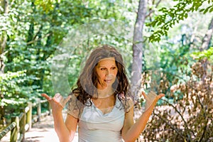 Busty classy mature woman doing welcome shaka sign