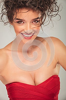 busty model in red dress smiling