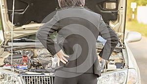 Busuness woman with her broken car.