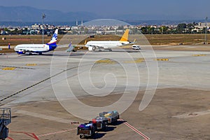 Busy airport with airplanes and service vehicles in Antalya, Turkey