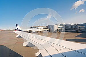 Busy airport view with airplanes against clear sky