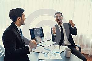 Busy analyst team discussing financial data on laptop. Fervent