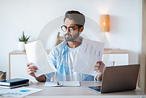 Busy Arab Male Entrepreneur Working With Papers And Laptop In Office