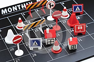 Busy black calendar with full of traffic  signs such as red pylons, no entry and no parking using as busy business calendar, full