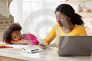 Busy Black Mother Working From Home, Ignoring Her Bored Little Daughter