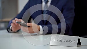 Busy budget analyst using smartphone, scrolling websites and zooming files