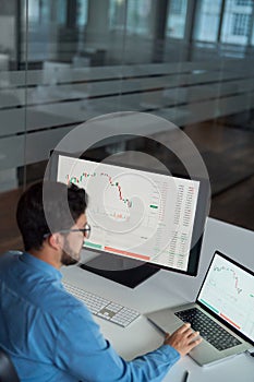 Busy business man broker analyst investor using computer analyzing stock market.