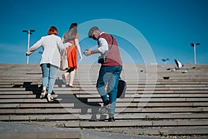 Busy business professionals walking up stairs outdoors in the city