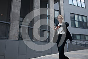 Busy Business Woman Checking Time while Hurry Up at Work. Lady Holding Coffee