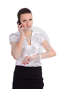 Busy business woman checking time while talking on