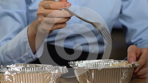 Busy business woman eating salad from food container, lunch box snack, meal