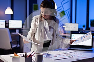 Busy business woman looking on financial reports