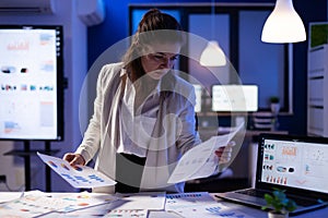 Busy business woman looking on financial reports