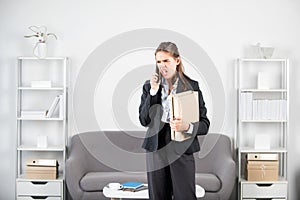 Busy business woman, secretary girl working alone late in office. Angry sad secretary, upset accountant employee talking