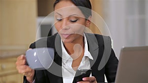 Busy business woman texting on her cell phone