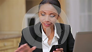 Busy business woman texting on her cell phone