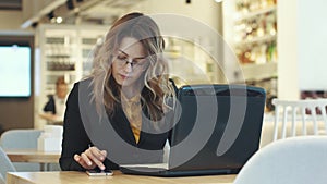 Busy business woman working in cafe