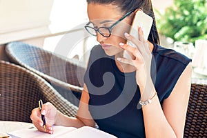 Busy business woman working in a cafe