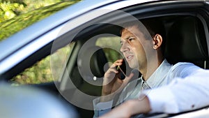 Busy businessman communicating on phone in car