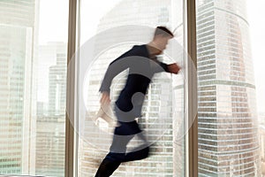 Busy businessman hurrying up, getting late, city view, motion bl