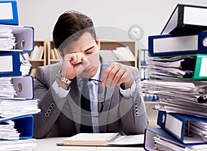 Busy businessman under stress due to excessive work