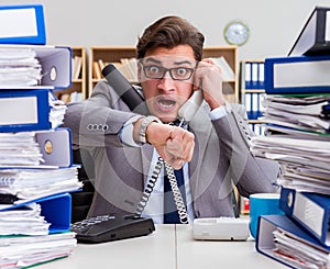 Busy businessman under stress due to excessive work