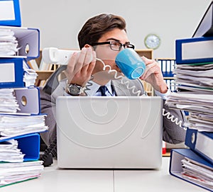 Busy businessman under stress due to excessive work