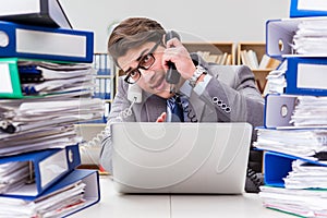 The busy businessman under stress due to excessive work