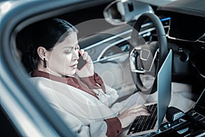 Busy businesswoman feeling overloaded arranging meeting by phone