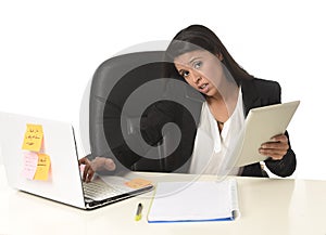 Busy businesswoman suffering stress working at office computer desk worried desperate