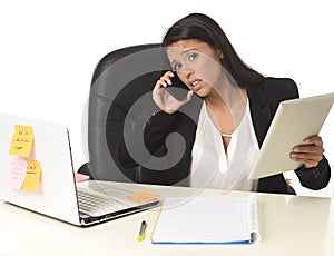 Busy businesswoman suffering stress working at office computer desk worried desperate