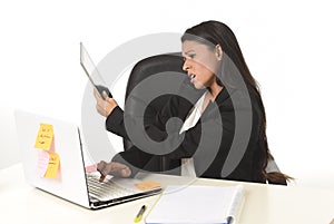 Busy businesswoman suffering stress working at office computer desk worried desperate