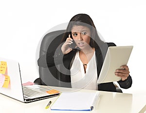 Busy businesswoman suffering stress working at office computer desk worried desperate