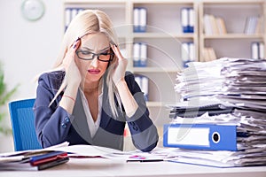 The busy businesswoman working in office at desk